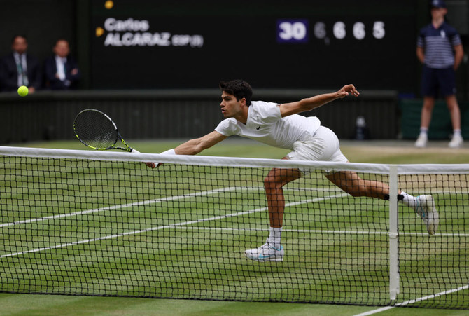 Carlos Alcaraz prepares for a powerful serve at Wimbledon.